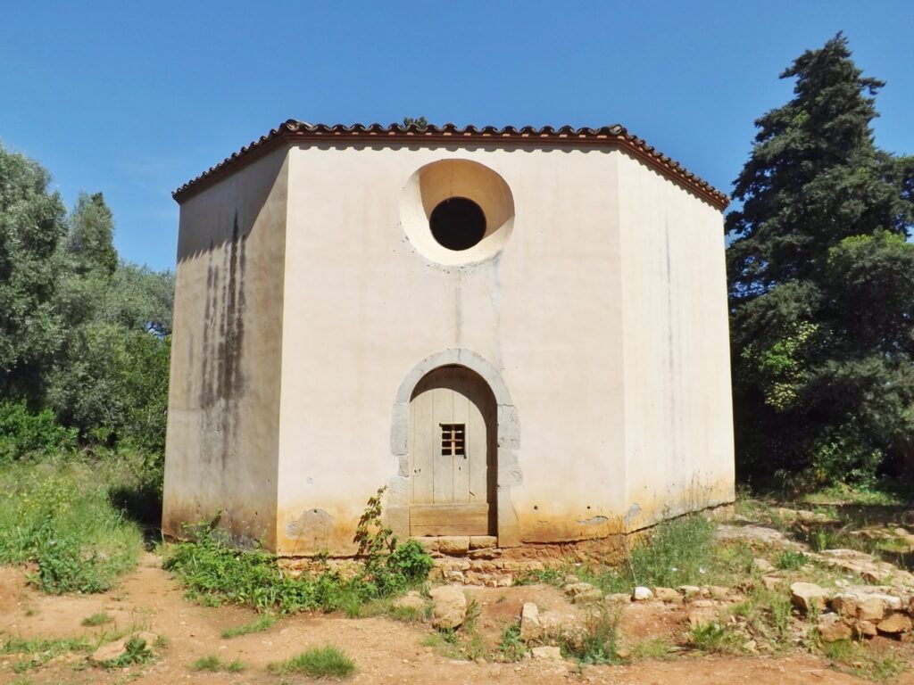 chapelle Saint-Sauveur entourée de nature et de pierres anciennes.